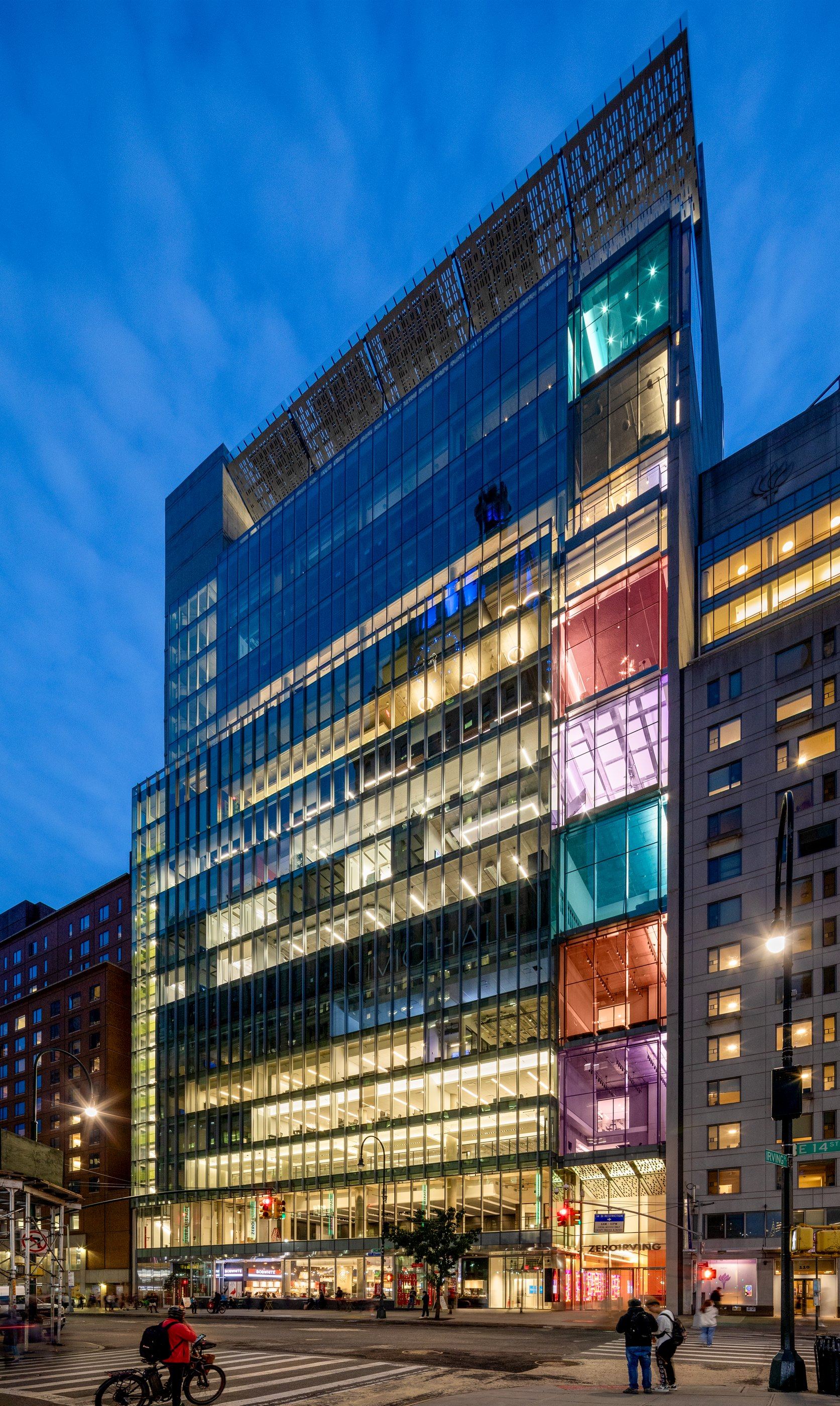 Zero Irving at dusk, its colored glass volumes lit above East 14th Street